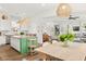 Open-concept kitchen with island seating that flows seamlessly into the adjacent dining and living areas at 383 Oak Park St, Summerville, SC 29486