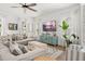 Cozy living room with neutral tones, a modern television, and large windows providing natural light at 383 Oak Park St, Summerville, SC 29486