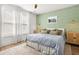 Serene main bedroom with ample natural light, soft green accents, and stylish furnishings at 383 Oak Park St, Summerville, SC 29486