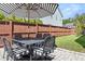 Outdoor dining set and umbrella on a stone patio with wood fence at 383 Oak Park St, Summerville, SC 29486
