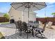 Outdoor dining area featuring a striped umbrella, a table with seating, and a grill, creating an inviting space at 383 Oak Park St, Summerville, SC 29486