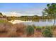 Scenic view of a pond reflecting the surrounding landscape and colorful trees, enhancing community charm at 383 Oak Park St, Summerville, SC 29486