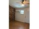 The bonus room features tile floors, a brick wall, a window and a door at 4324 Purdue Dr, North Charleston, SC 29418