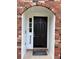 A closer view of the arched doorway showcasing a dark front door with sidelight at 4324 Purdue Dr, North Charleston, SC 29418