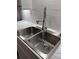 Close up of a stainless steel, dual-basin sink with a modern faucet and subway tile backsplash at 4324 Purdue Dr, North Charleston, SC 29418