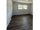 Bright bedroom with hardwood floors, a closet and ample light from the double windows at 4626 W W Montague Ave, North Charleston, SC 29418