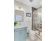 Bathroom featuring vanity with a white countertop, brass faucet and a glass shower with gray subway tiles at 503 Ivy Green Ln, Summerville, SC 29486