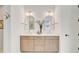 Elegant bathroom with double vanity, arched mirrors, decorative lights, cabinets, and hardware at 503 Ivy Green Ln, Summerville, SC 29486