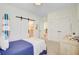 Light-filled bedroom with a barn door leading to an ensuite bath at 503 Ivy Green Ln, Summerville, SC 29486