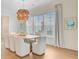 Stylish dining room with a unique chandelier, light curtains, and hardwood flooring at 503 Ivy Green Ln, Summerville, SC 29486
