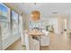Open-concept dining area with modern lighting, white chairs, and hardwood floors at 503 Ivy Green Ln, Summerville, SC 29486