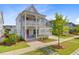 Charming two-story home with a double porch, a two-car garage, and a well-manicured lawn at 503 Ivy Green Ln, Summerville, SC 29486