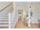 Bright foyer featuring hardwood floors, a staircase, and a view into the dining area at 503 Ivy Green Ln, Summerville, SC 29486