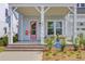 Inviting front porch with seating area, a pink door, and beautiful landscaping at 503 Ivy Green Ln, Summerville, SC 29486