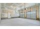 Spacious unfinished two car garage with high ceilings and neutral paint at 503 Ivy Green Ln, Summerville, SC 29486