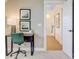 Cozy office nook with a modern desk, stylish green chair, and peaceful artwork at 503 Ivy Green Ln, Summerville, SC 29486
