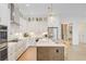 Bright kitchen features white cabinets, stainless steel appliances, pendant lighting, and a large island with seating at 503 Ivy Green Ln, Summerville, SC 29486