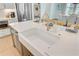 Close-up of the kitchen island features a white farmhouse sink and gold faucet, ready for gourmet meals at 503 Ivy Green Ln, Summerville, SC 29486