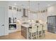 Bright kitchen features white cabinets, stainless steel appliances, pendant lighting, and a large island with seating at 503 Ivy Green Ln, Summerville, SC 29486
