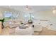 Cozy living room with white sofa, shaggy swivel chairs, wood floors, and sunny windows at 503 Ivy Green Ln, Summerville, SC 29486
