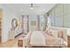 Bright and spacious main bedroom with wood floors, stylish furnishings, and plenty of natural light at 503 Ivy Green Ln, Summerville, SC 29486