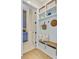 A well-organized mudroom with built-in shelving, seating, and storage baskets with access to laundry room at 503 Ivy Green Ln, Summerville, SC 29486