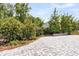 Beautiful backyard with lush greenery, and lovely pavers leading to an area to build a fire pit at 512 Pontoon Rd, Huger, SC 29450