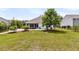 Wide backyard and a screened in porch with a blue chair at 512 Pontoon Rd, Huger, SC 29450