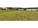 Spacious backyard with lush grass and a black fence, offering privacy and a serene outdoor space at 512 Pontoon Rd, Huger, SC 29450