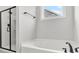 Bathroom featuring soaking tub, shower, and a window with a view at 512 Pontoon Rd, Huger, SC 29450
