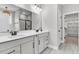Bright bathroom features double vanity, framed mirrors, and a walk-in closet at 512 Pontoon Rd, Huger, SC 29450