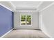 Bright bedroom with large window, neutral paint, and carpeted floors offer a cozy retreat at 512 Pontoon Rd, Huger, SC 29450