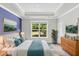 This main bedroom features a tray ceiling, a window, and beautiful decor at 512 Pontoon Rd, Huger, SC 29450