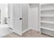 A spacious walk-in closet with built-in shelving and open door to an adjacent room at 512 Pontoon Rd, Huger, SC 29450