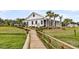 Charming community center with a welcoming walkway, surrounded by lush landscaping at 512 Pontoon Rd, Huger, SC 29450