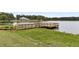 Community wooden dock on the water with green grass and landscaping surrounding it at 512 Pontoon Rd, Huger, SC 29450