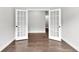Empty room featuring hardwood floors and glass french doors to the hallway at 512 Pontoon Rd, Huger, SC 29450