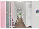 Bright hallway with hardwood floors, white walls, and white doors leading to a large living space at 512 Pontoon Rd, Huger, SC 29450
