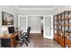 Bright home office features hardwood floors, French doors, a desk, and a built-in bookshelf at 512 Pontoon Rd, Huger, SC 29450