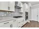 Sleek kitchen design with white cabinets, quartz countertops, and stainless steel appliances at 512 Pontoon Rd, Huger, SC 29450