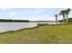 Scenic lake view with a wooden dock and lush green grass leading to the shoreline at 512 Pontoon Rd, Huger, SC 29450
