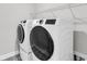 Modern laundry room with front loading washer and dryer on beautiful tile floors at 512 Pontoon Rd, Huger, SC 29450