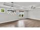 Spacious living room with hardwood floors, many windows, neutral paint, and stylish chandelier at 512 Pontoon Rd, Huger, SC 29450