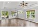Open living room with recessed lighting, many windows, ceiling fan, and slider to the patio at 512 Pontoon Rd, Huger, SC 29450