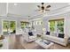 Beautiful living room with recessed lighting, ceiling fan, lots of windows, and white furniture at 512 Pontoon Rd, Huger, SC 29450