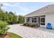 Lovely outdoor patio and screened in back porch with beautiful greenery and pavers throughout the backyard at 512 Pontoon Rd, Huger, SC 29450