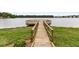 Inviting wooden walkway leading to a private dock, perfect for enjoying the serene lake at 512 Pontoon Rd, Huger, SC 29450