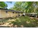 Lush backyard featuring a brick exterior, ample green space, and a wooden privacy fence at 520 Yale Dr, Charleston, SC 29412