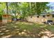 Large backyard featuring a treehouse, trampoline, and other outdoor recreational equipment at 520 Yale Dr, Charleston, SC 29412