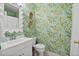 Unique bathroom with bright wallpaper, a modern vanity with a decorative mirror, and a toilet at 520 Yale Dr, Charleston, SC 29412